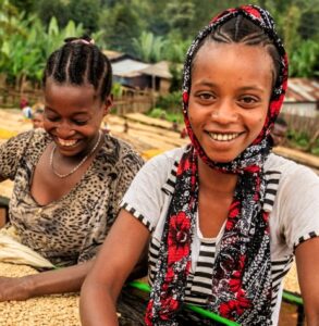 Woman of colour sitting and smiling